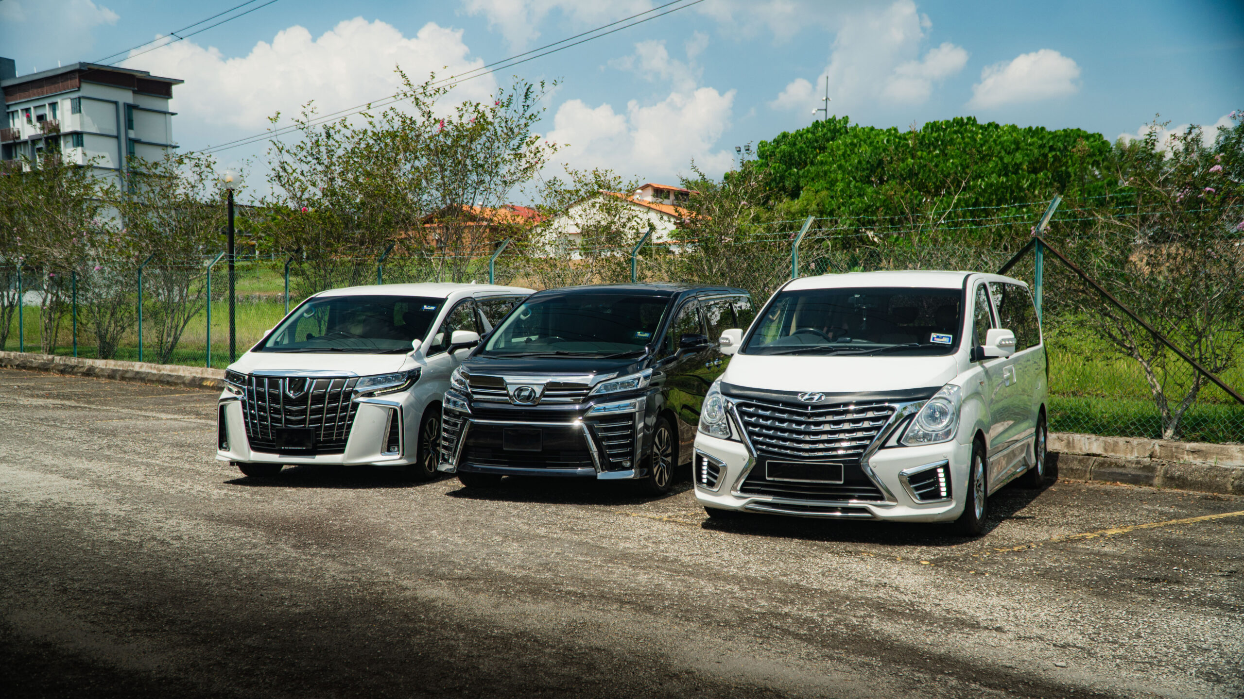 Starex, Vellfire and Alphard parking side by side to showcase our available MPV for airport transfers.